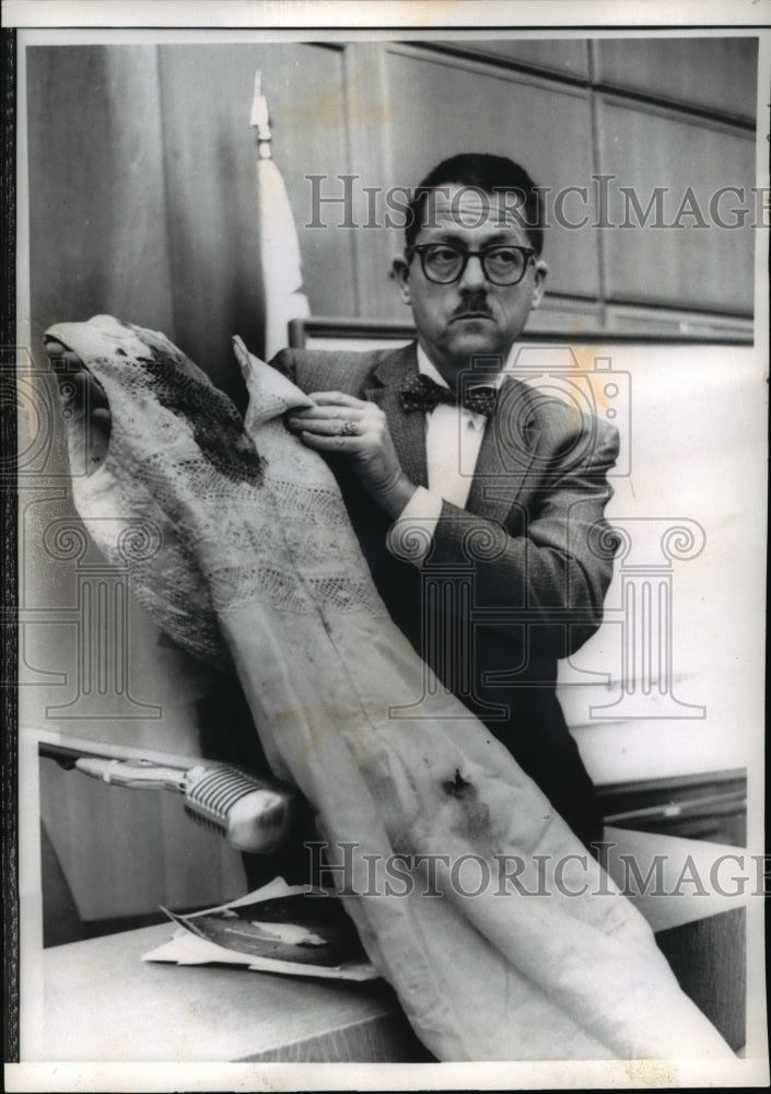 1960 Press Photo Deputy Medical Examiner Gerald K Ridge holds dress of B. Finch - Historic Images