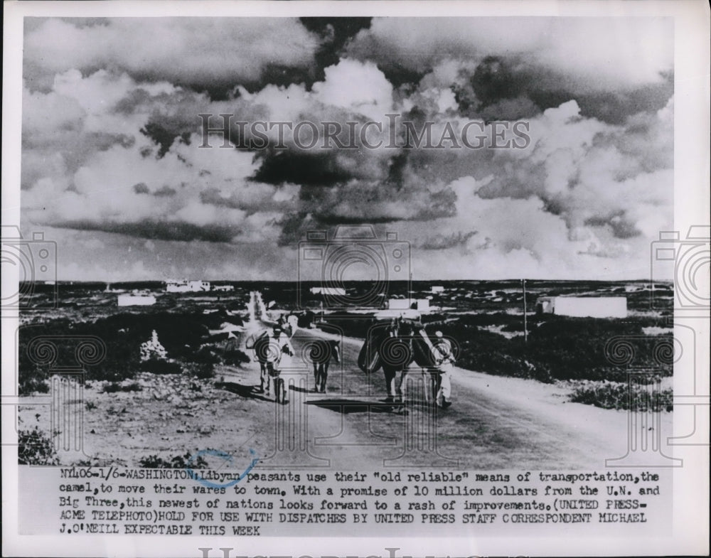 1952 Press Photo Libyan peasants on camel to move from wares to town - Historic Images