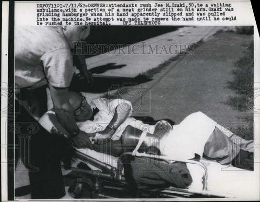 1962 Press Photo Joe M.Ozakiwith with a meat grinder on his arm - Historic Images