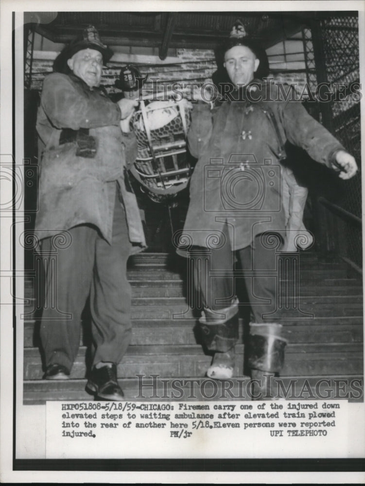 1959 Press Photo Fireman carry injured down elevated steps after train plowed - Historic Images