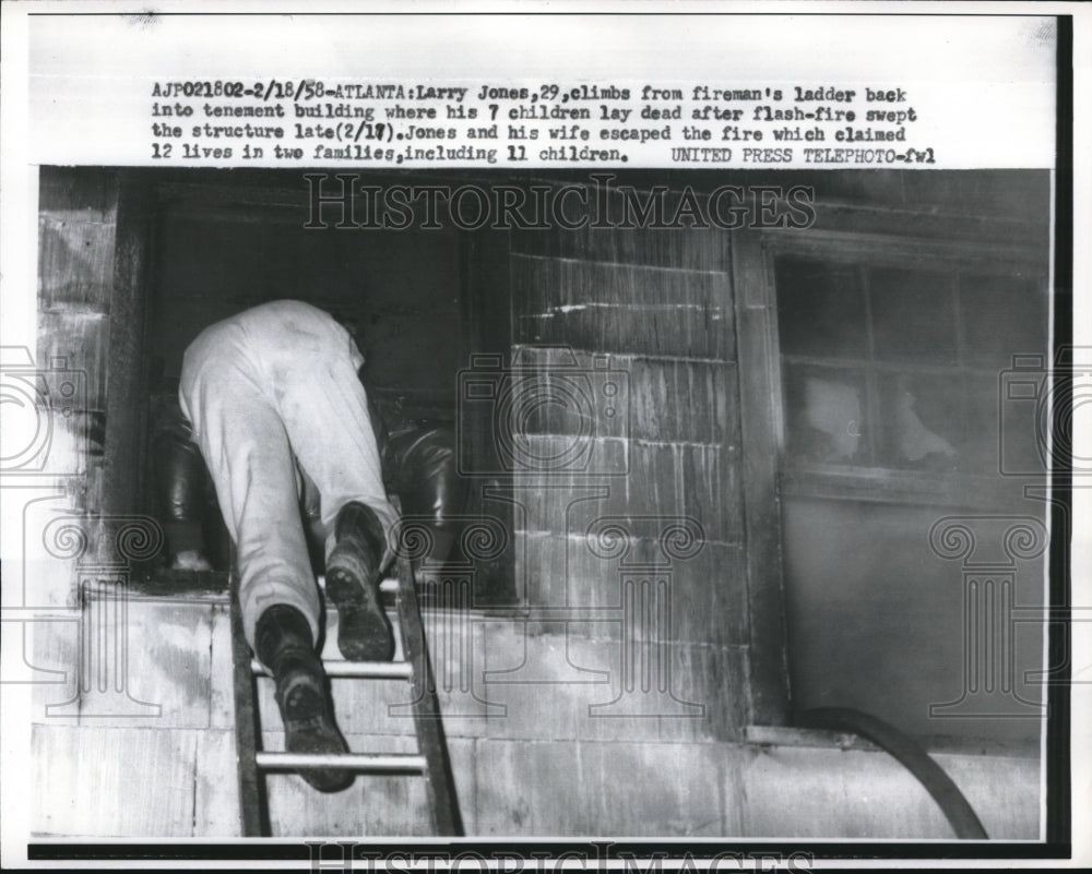 1958 Press Photo Larry Jones, 29, climbs from ladder back into tenement building - Historic Images