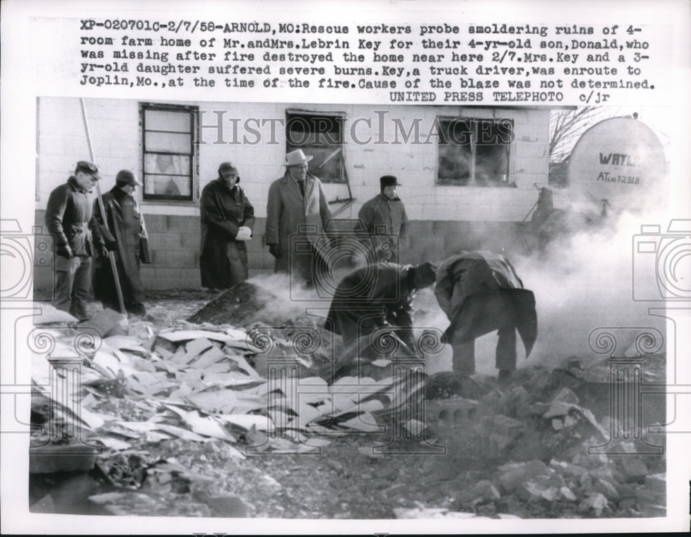 1958 Press Photo Rescue Workers probe smoldering ruins of 4 room farm home - Historic Images