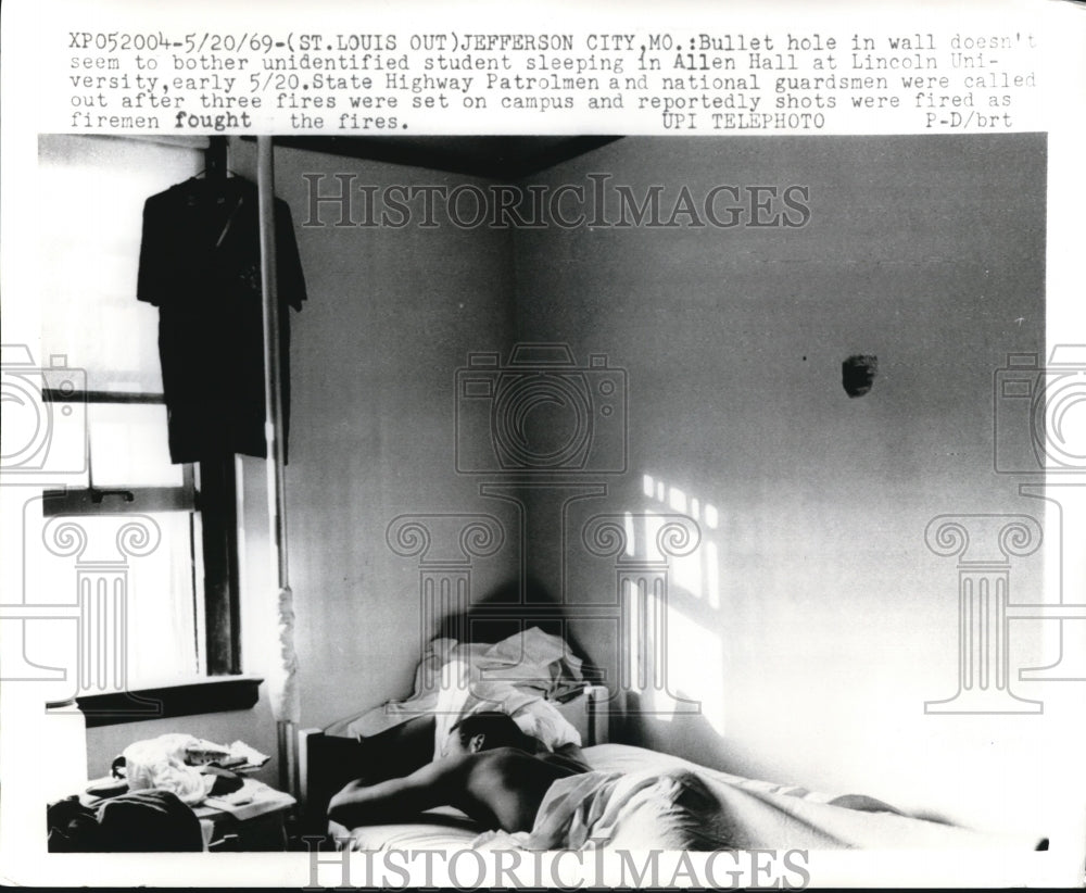 1969 Press Photo Jefferson City Mo Bullet hole in wall doesn't seem to bother - Historic Images