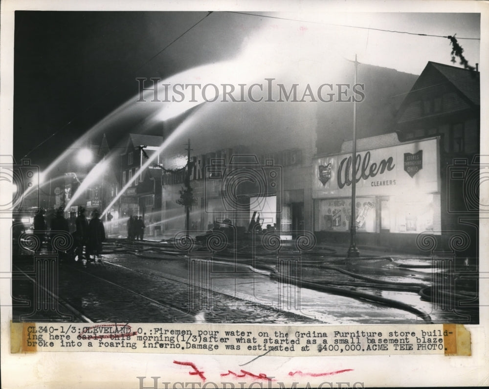 1949 Press Photo Firemen pour water  to Grdina Furniture store after it blazed - Historic Images