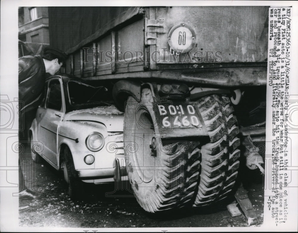 1960 Press Photo Milan car under truck, driver unhurt - Historic Images