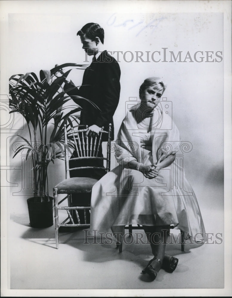 1957 Press Photo A woman sitting in pose in her first formal dress - Historic Images