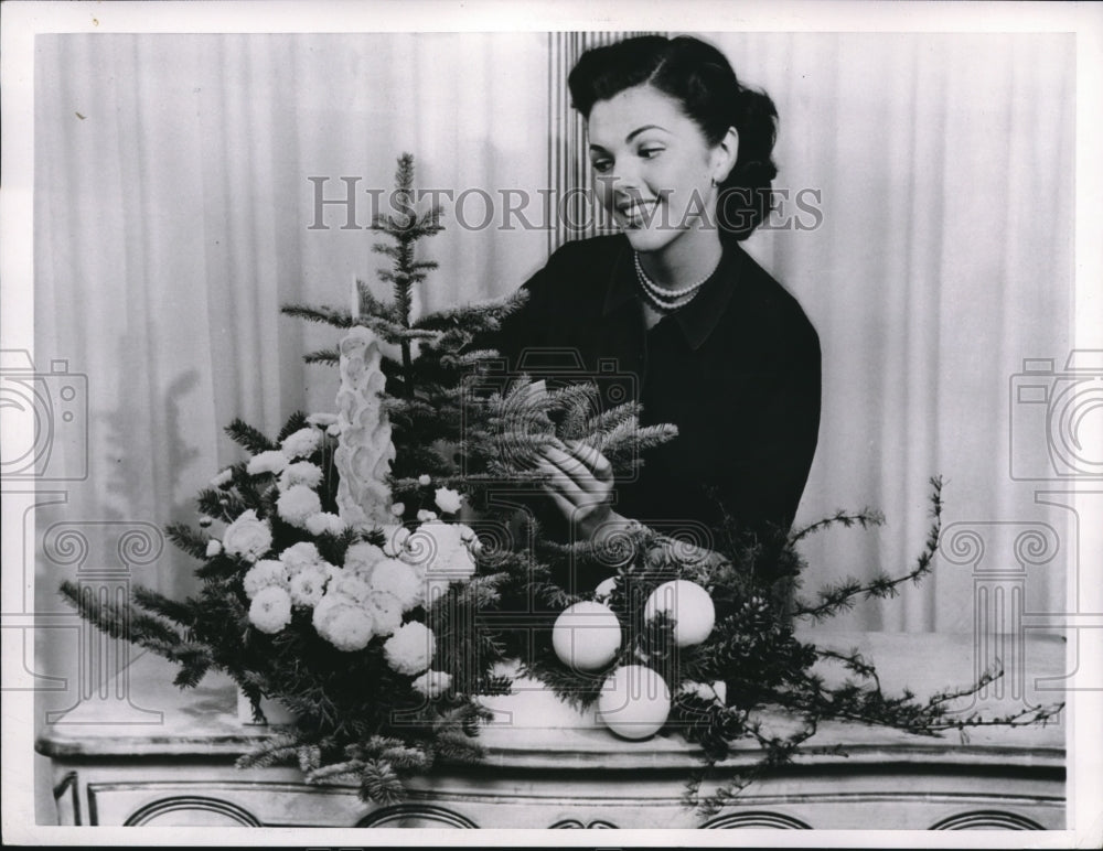 1959 Woman decorating a tree for Christmas-Historic Images