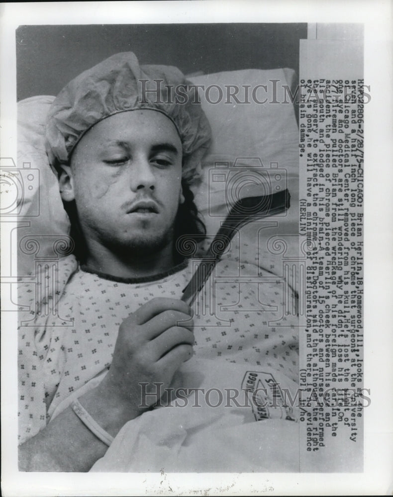 1975 of Brian Herlin looking at the piece of metal doctors removed-Historic Images