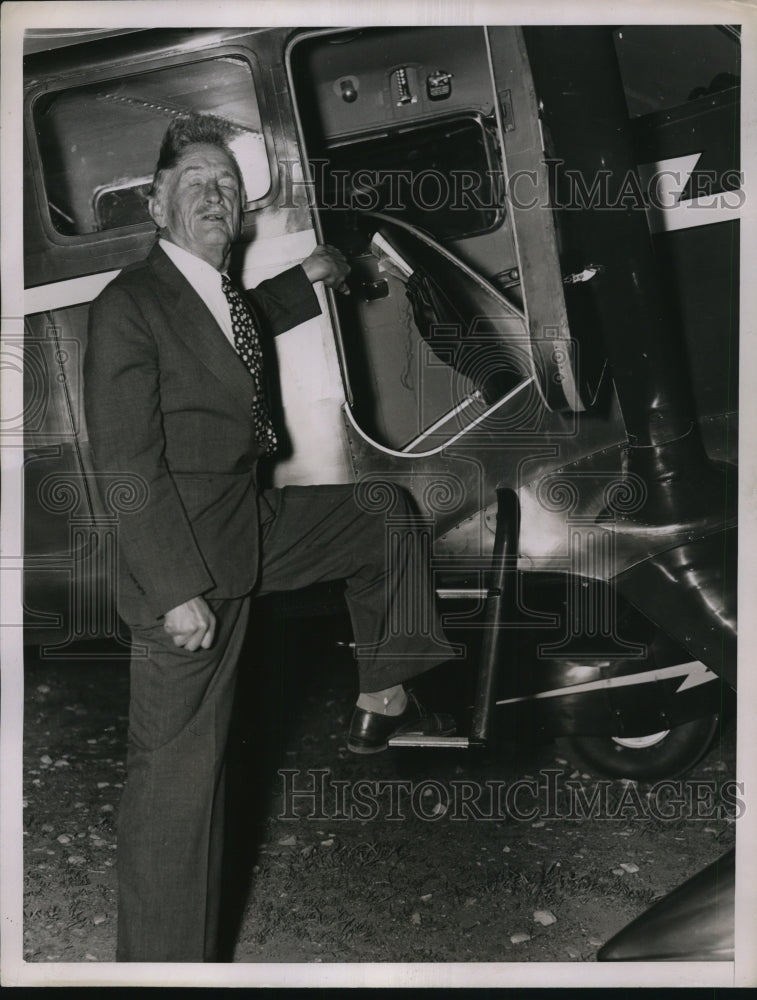 1937 Mr. McFadden entering the plane - Historic Images