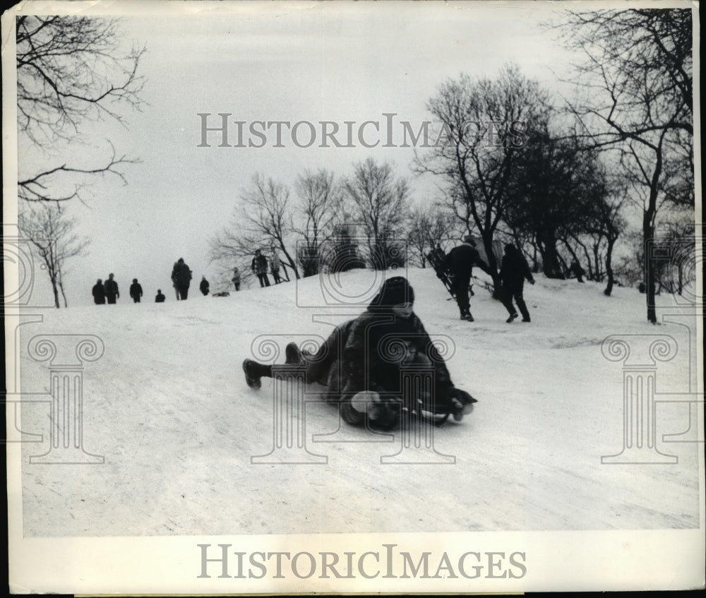 1969 Chicago Ill kids on sleds on snowy hill in a park - Historic Images