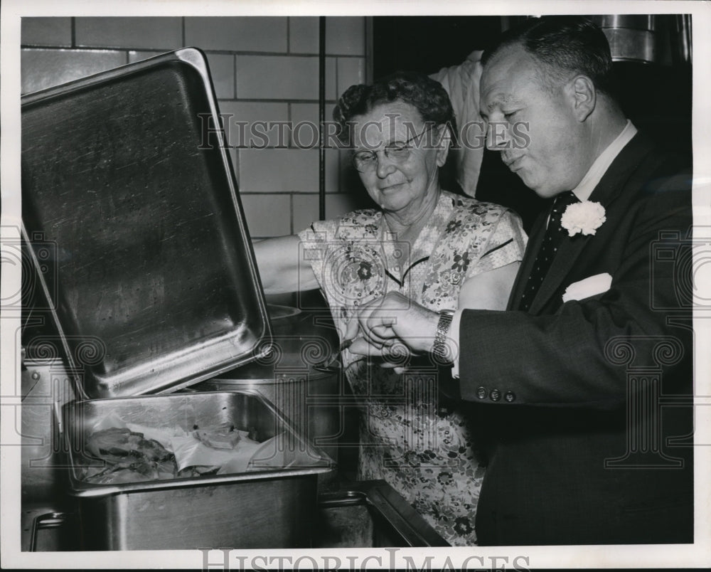 1956 Press Photo of Michael DiSalle trying some ham from Mrs. Katie Compton. - Historic Images