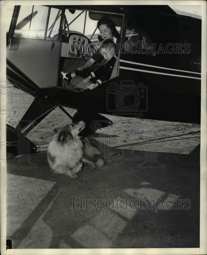 1941 of Schanz family waiting for takeoff. - Historic Images