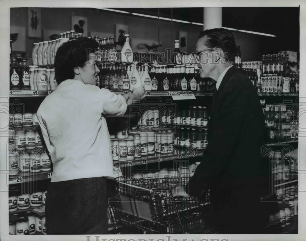 1958 Gov Philip A. Hart corners Mrs. Herman Zachriason in Muskegon - Historic Images