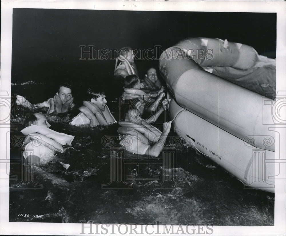 1953 Pilots and crew members swim to Survival Rafts - Historic Images