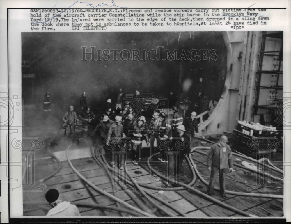 1960 Press Photo Firemen and rescue carry victims from ship that burnt, Brooklyn-Historic Images