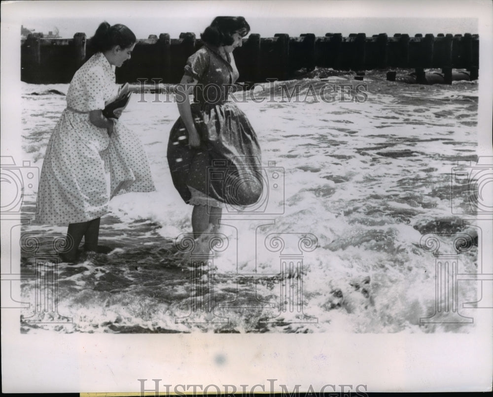 1957 Cooling their feet feet in the Cool Atlantic Beach, N.Y. - Historic Images