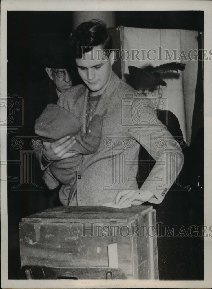 1947 Allis Chalmers Drops His Ballot As He Carries His Child-Historic Images