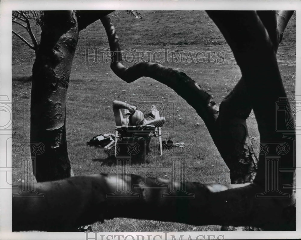 1965 A bald man sun bathing at Edgewater Park in Cleveland Ohio-Historic Images