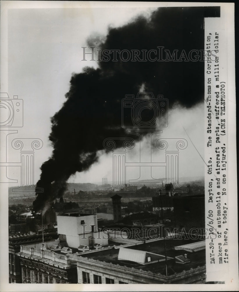 1950 Press Photo Smoke rises from Standard-Thomson Corporation building - Historic Images