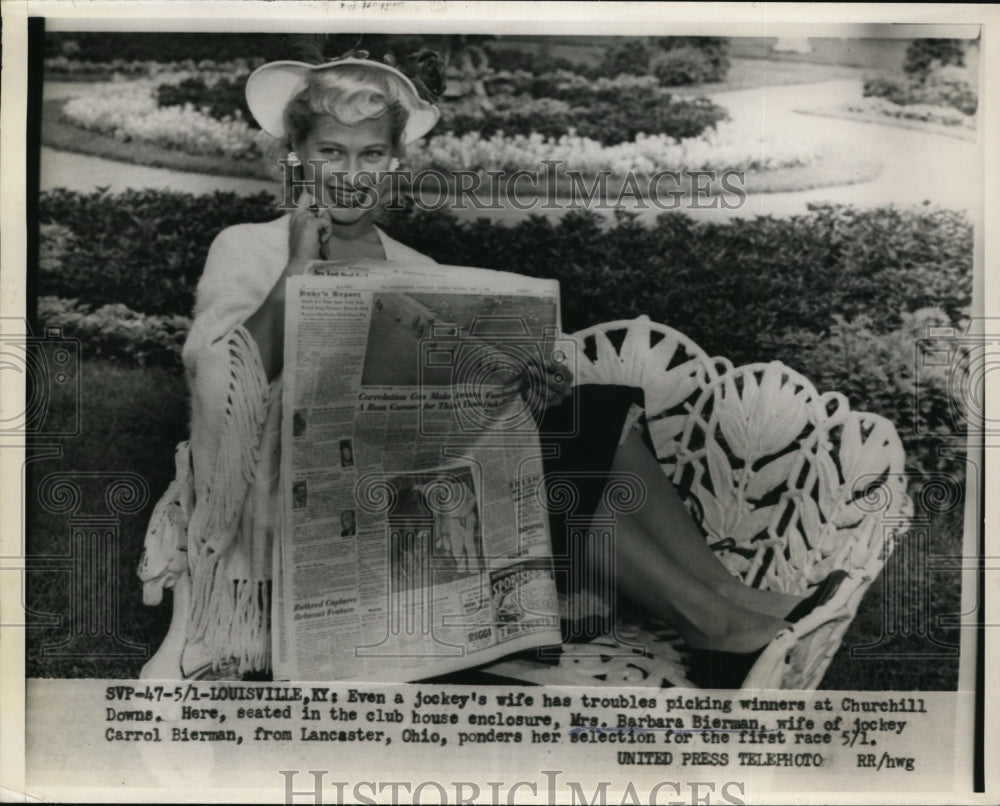 1954 Press Photo Jockey&#39;s Wife Ponders Selection for the First Race on May 1 - Historic Images