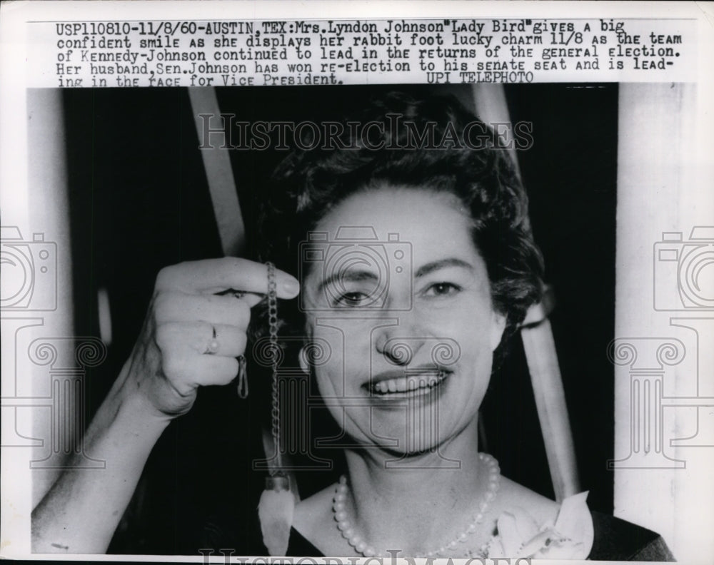 1960 Press Photo Mrs. Johnson gives a big smile as she displays her rabbit foot - Historic Images