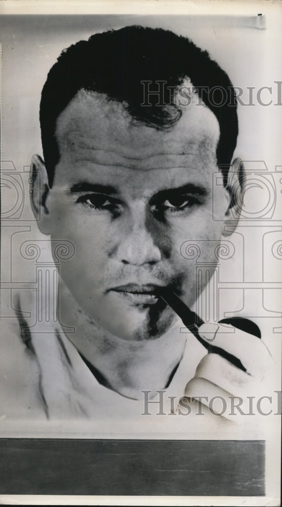 1964 Press Photo Samuel H. Sheppard appears thoughtful as he smokes a pipe - Historic Images