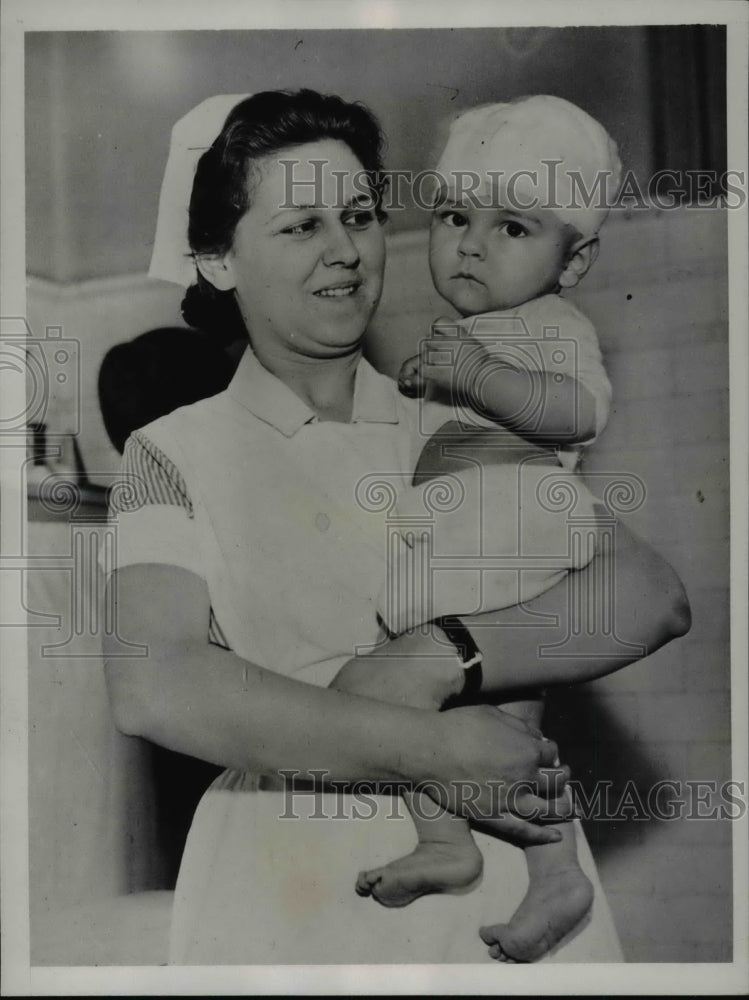 1935 Nurse holding Baby James Leory Fitz After Slashing Accident - Historic Images