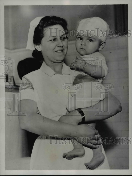 1935 Nurse holding Baby James Leory Fitz After Slashing Accident - Historic Images
