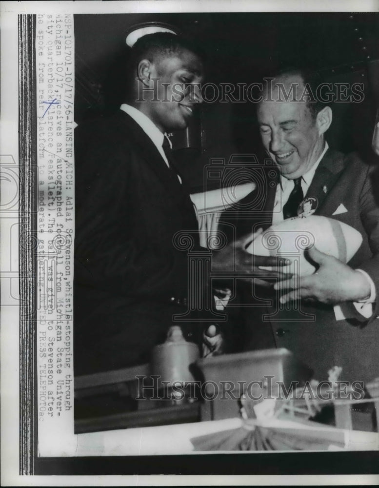 1956 Stevenson receives autographed football from quarterback Peaks - Historic Images