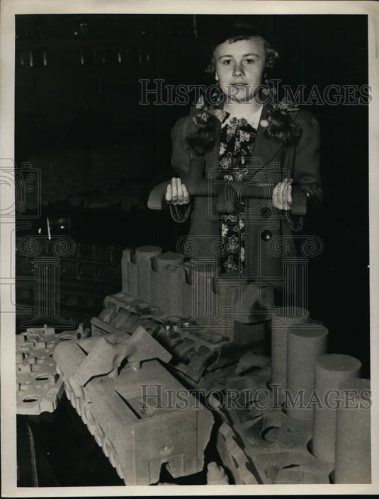 Ruth Ruth Jones with molded part of a Cadillac at the Foundry show - Historic Images