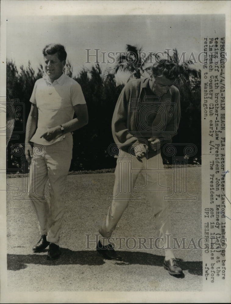 1961 Peter Lawford limbers up before teeing off with John F. Kennedy - Historic Images