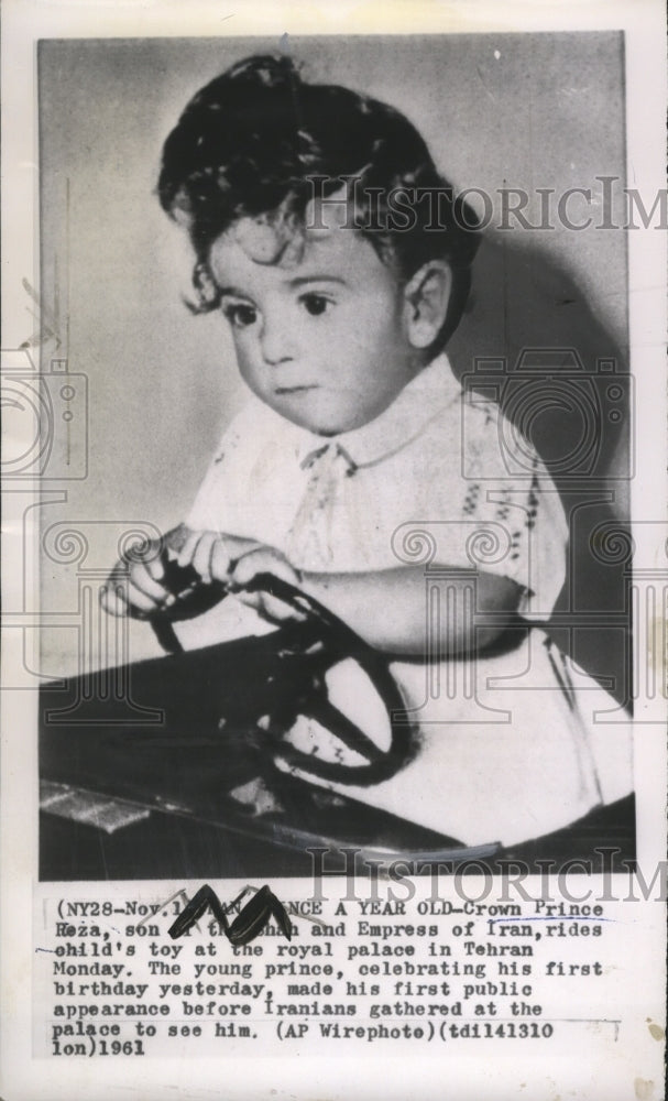 1961 Crown Prince Heza rides on child&#39;s toy at the royal palace - Historic Images