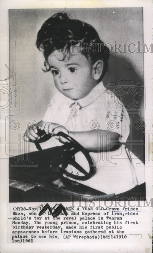 1961 Crown Prince Heza rides on child's toy at the royal palace - Historic Images