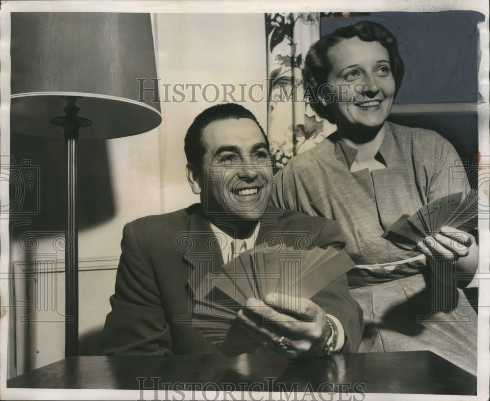 1954 Lou Boudreau, wife flashes tickets for the Sentinel Sports Show - Historic Images