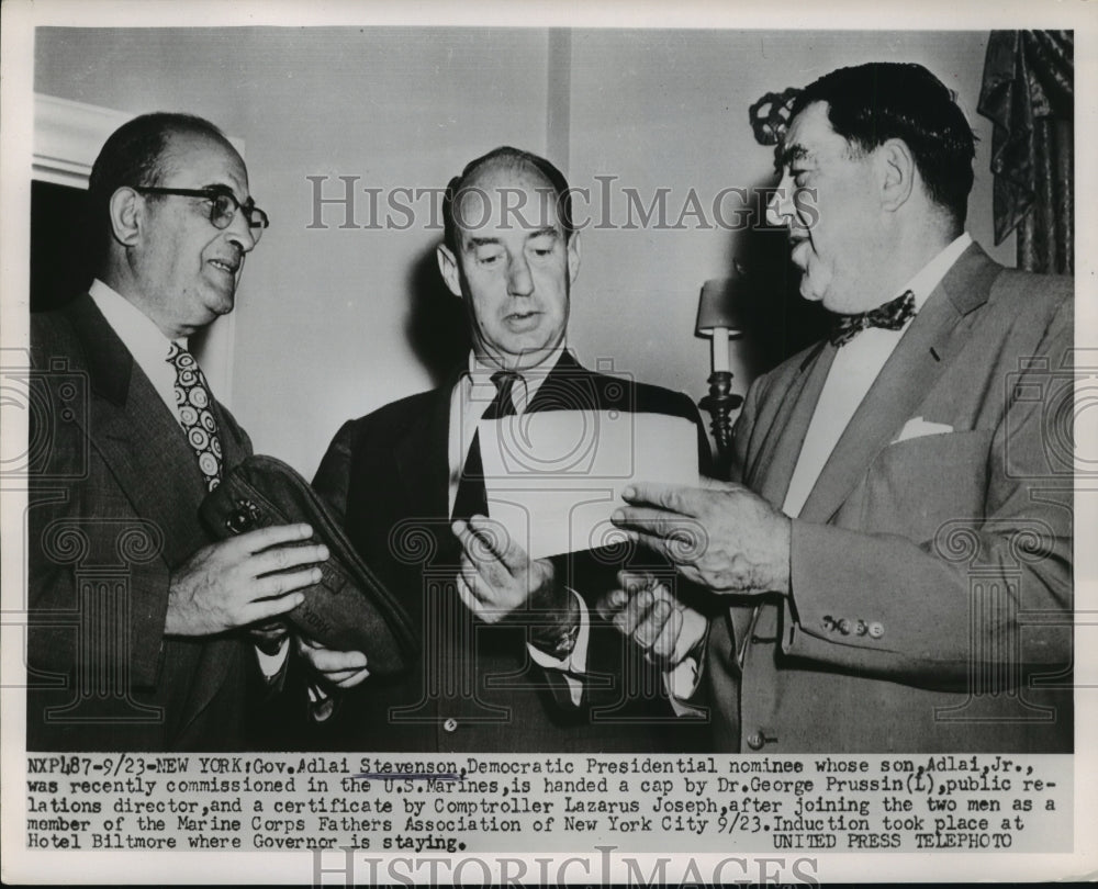 1952 Adlai Stevenson handed a cap by George Prussin  - Historic Images