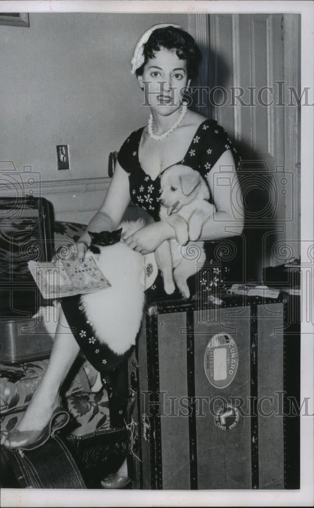 1955 Paula Aiello sits atop of her luggage holding pet dog and cat - Historic Images