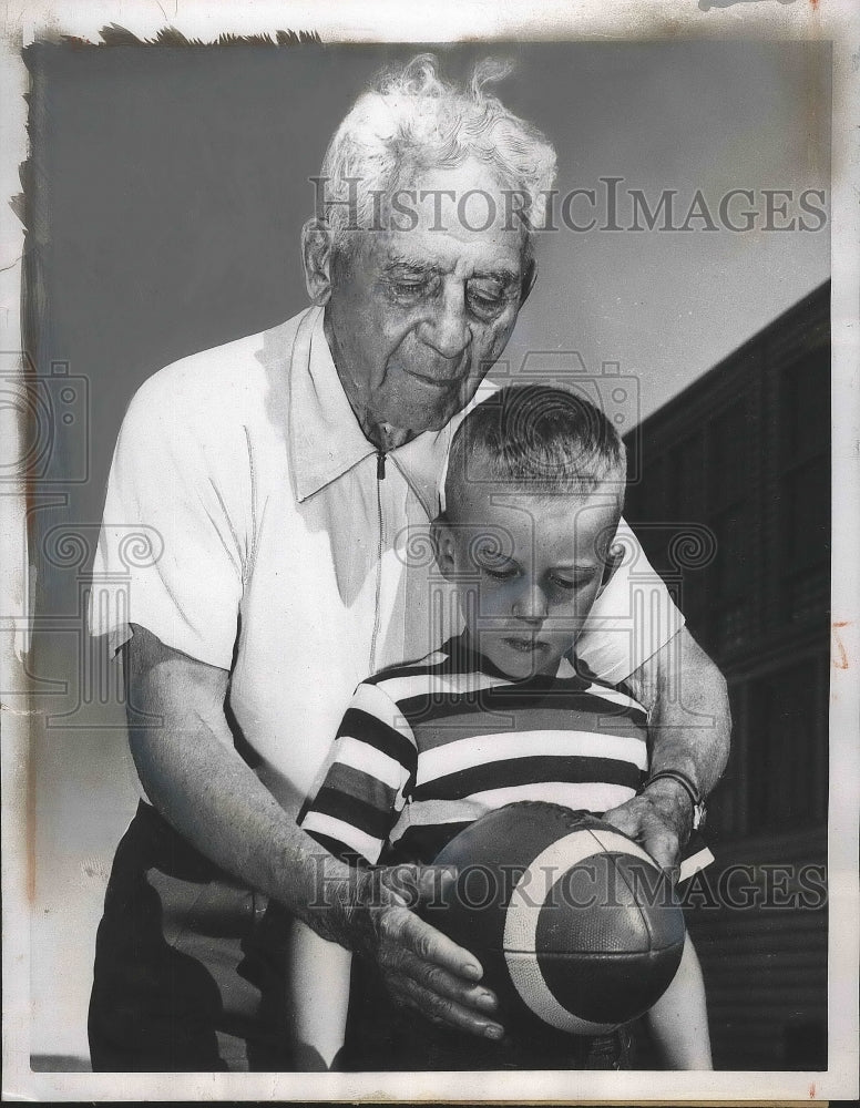1955 Amos Alonzo Stagg Starts Billy Barton Off with Pigskin - Historic Images