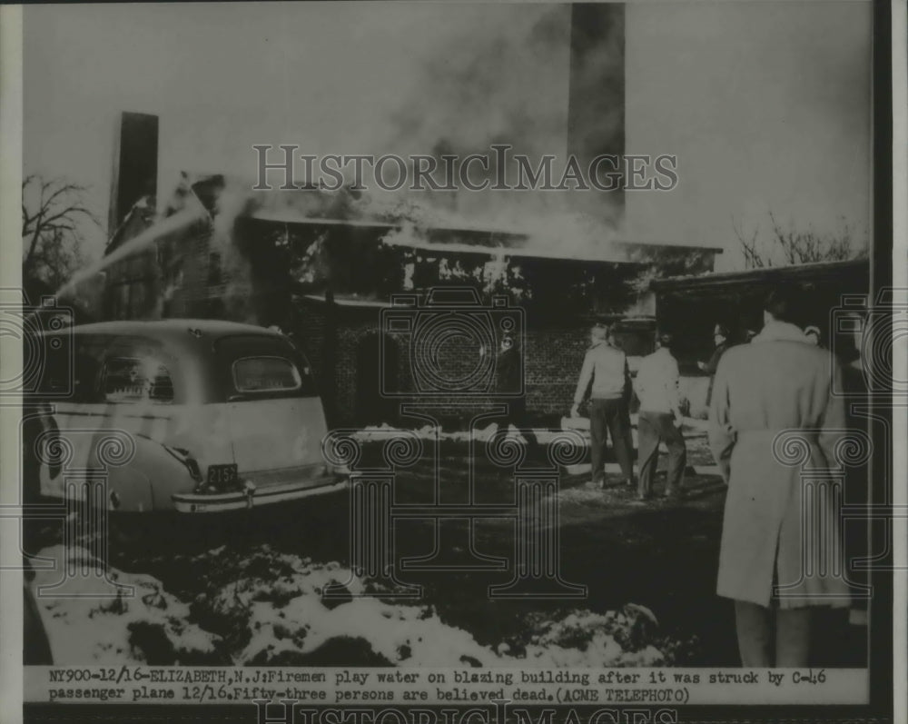 1951 Fireman Pour Water on Building After Struck by C - Historic Images