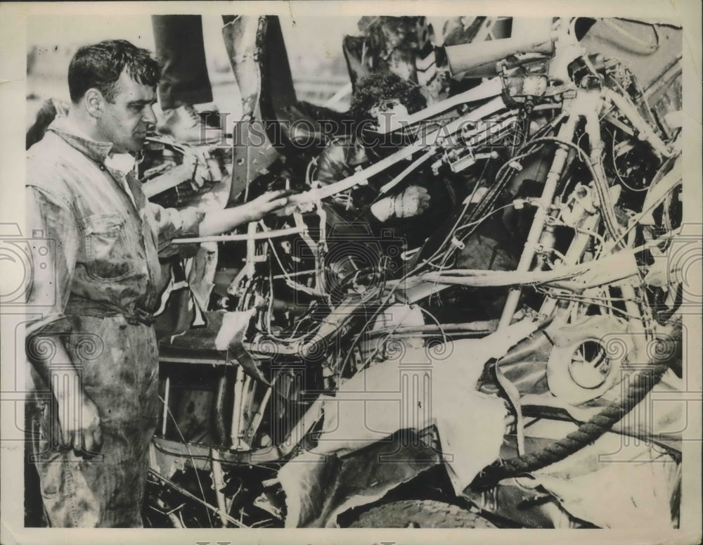 1936 Army Mechanic looking at a Army Wrecked Plane at East Boston - Historic Images