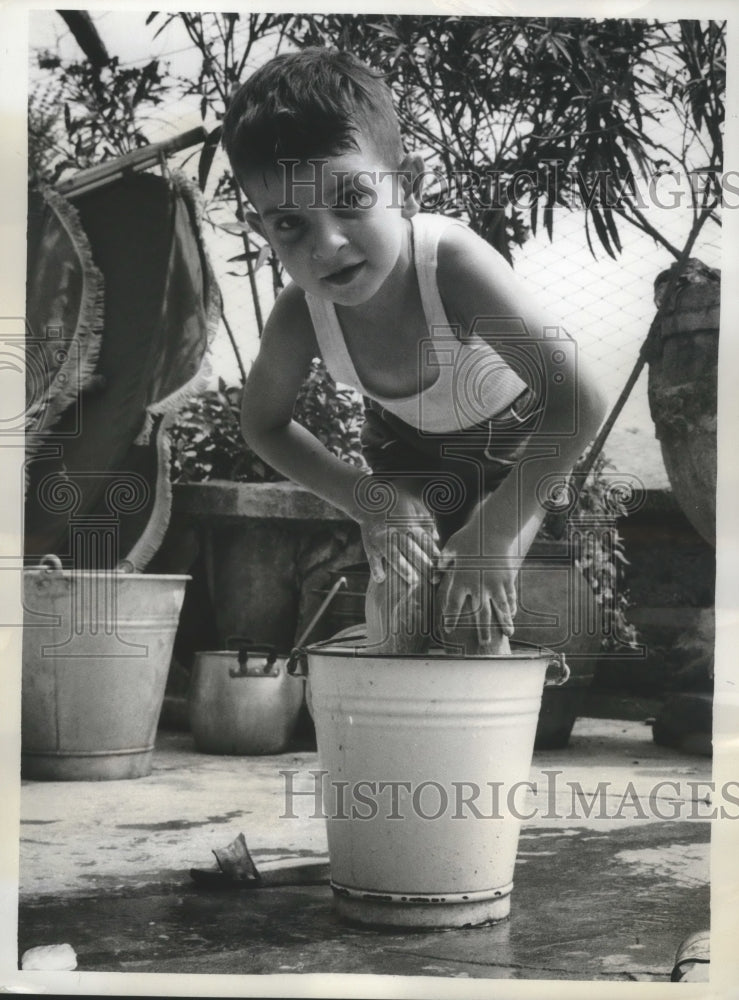 1962 Press Photo Young Italian Boy enjoys a bath in his backyard at Milan Italy - Historic Images