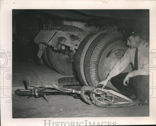 1955 A officer examines a bicycle  at scene of an accident - Historic Images
