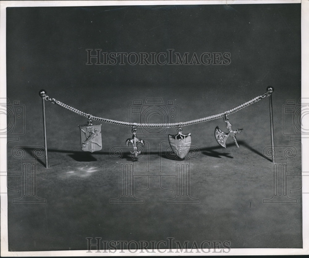 1951 Press Photo Charms on a chain attached to two stick pins - nef70197-Historic Images