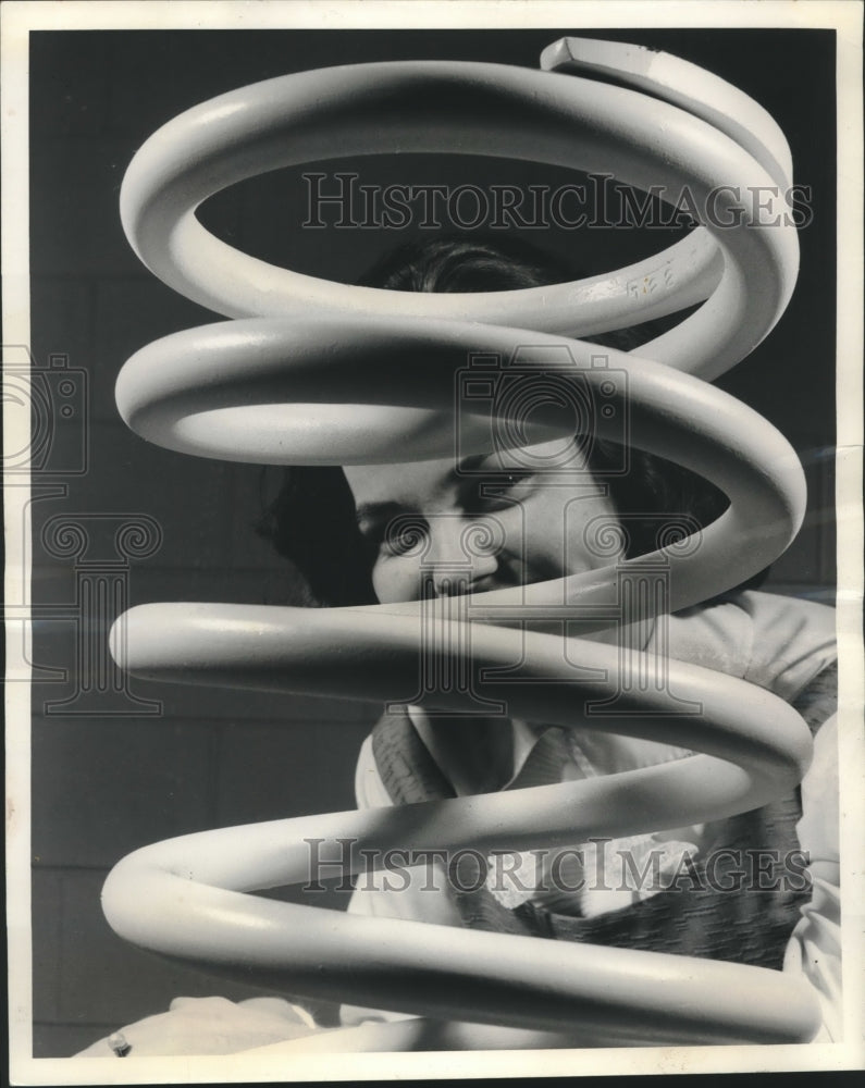 1964 Woman poses with spring to be used with Titan II missile system - Historic Images