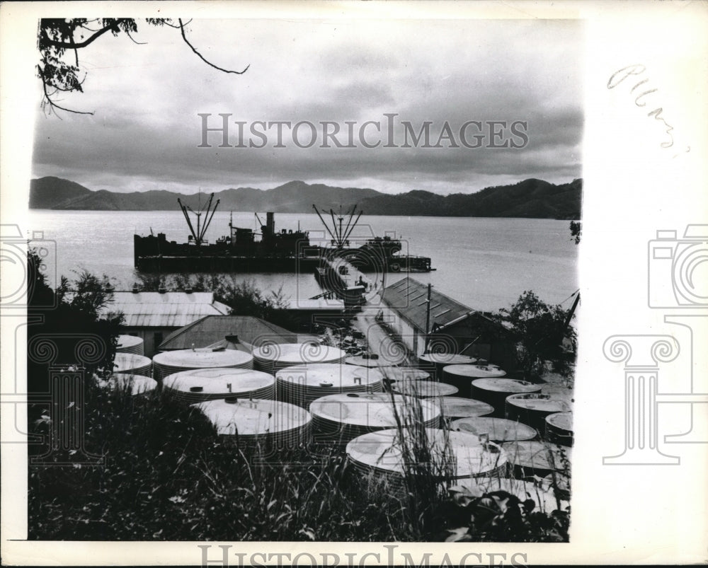 1942 Oil Tanks at Port Moresby with an Allied Vessel at dock. - Historic Images