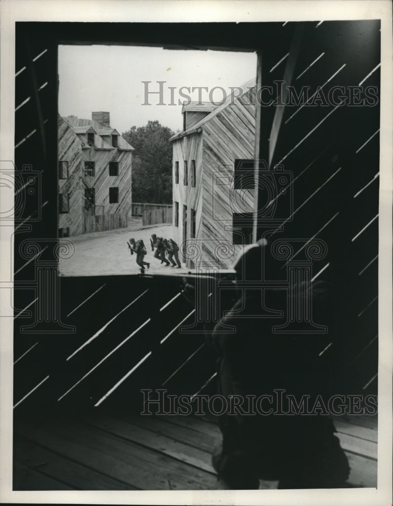 1952 Sniper firing at soldier in the street in manuevers - Historic Images