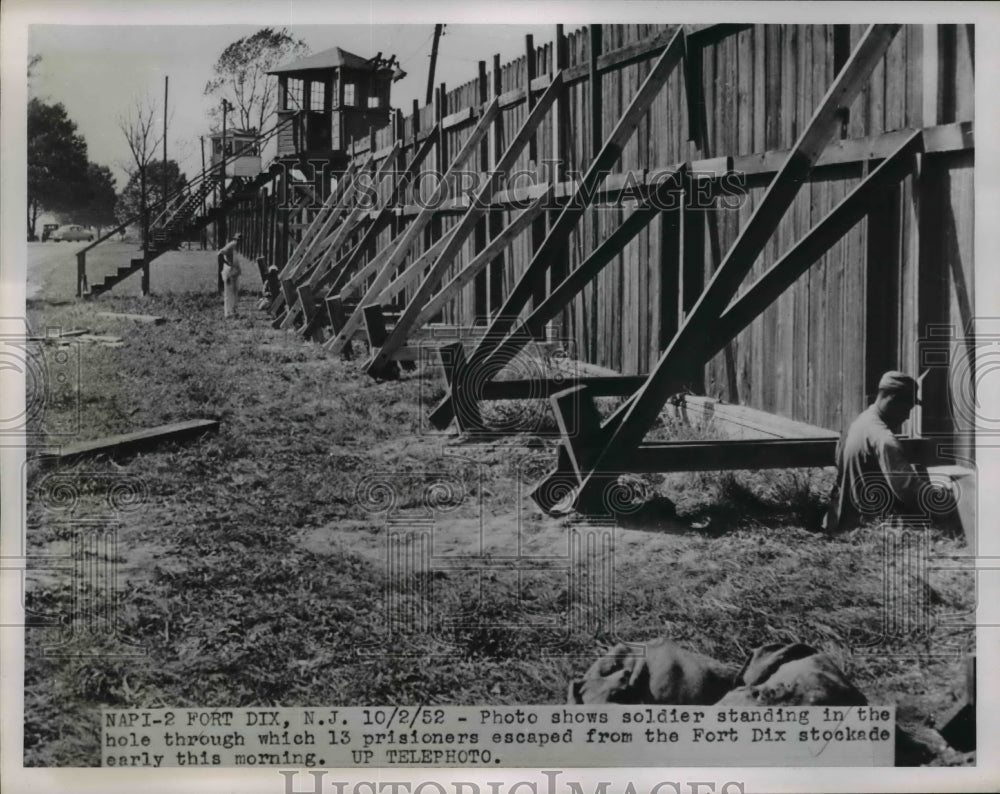 1952 Press Photo Soldier at Ft Dix repairs hole in fence  prisoners escaped thru - Historic Images