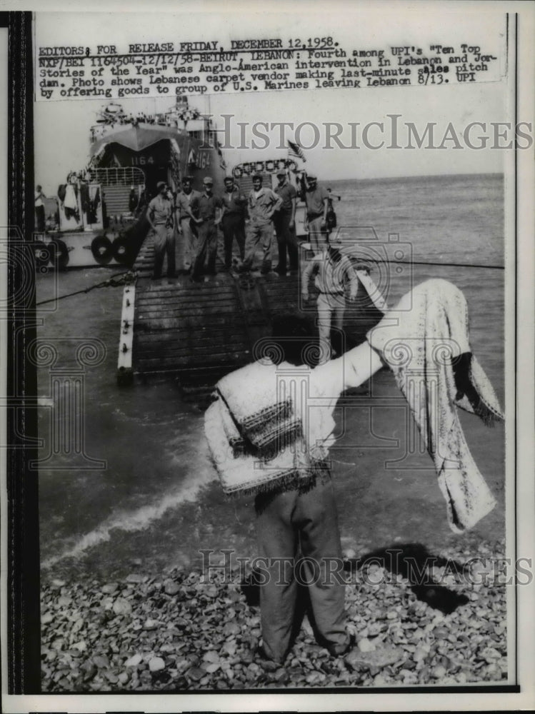 1958 Press Photo Beirut Lebanon carpet vendor makes sales to departing Marines-Historic Images