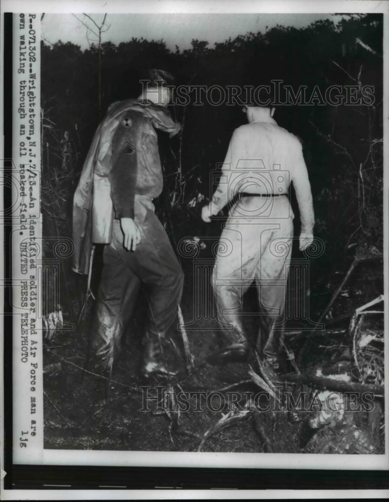 1956 Press Photo Wrightstown NJ USAF man at oil soaked field from a crash-Historic Images