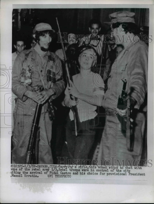 1958 Press Photo Woman With Rifle Stops to Chat With Rebel Army Troops-Historic Images