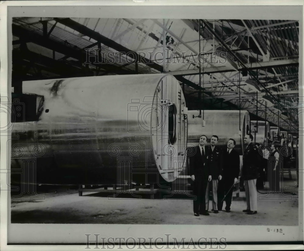 Press Photo Men in plane warehouse - nem48591-Historic Images